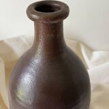 Old bottle in matte brown stoneware