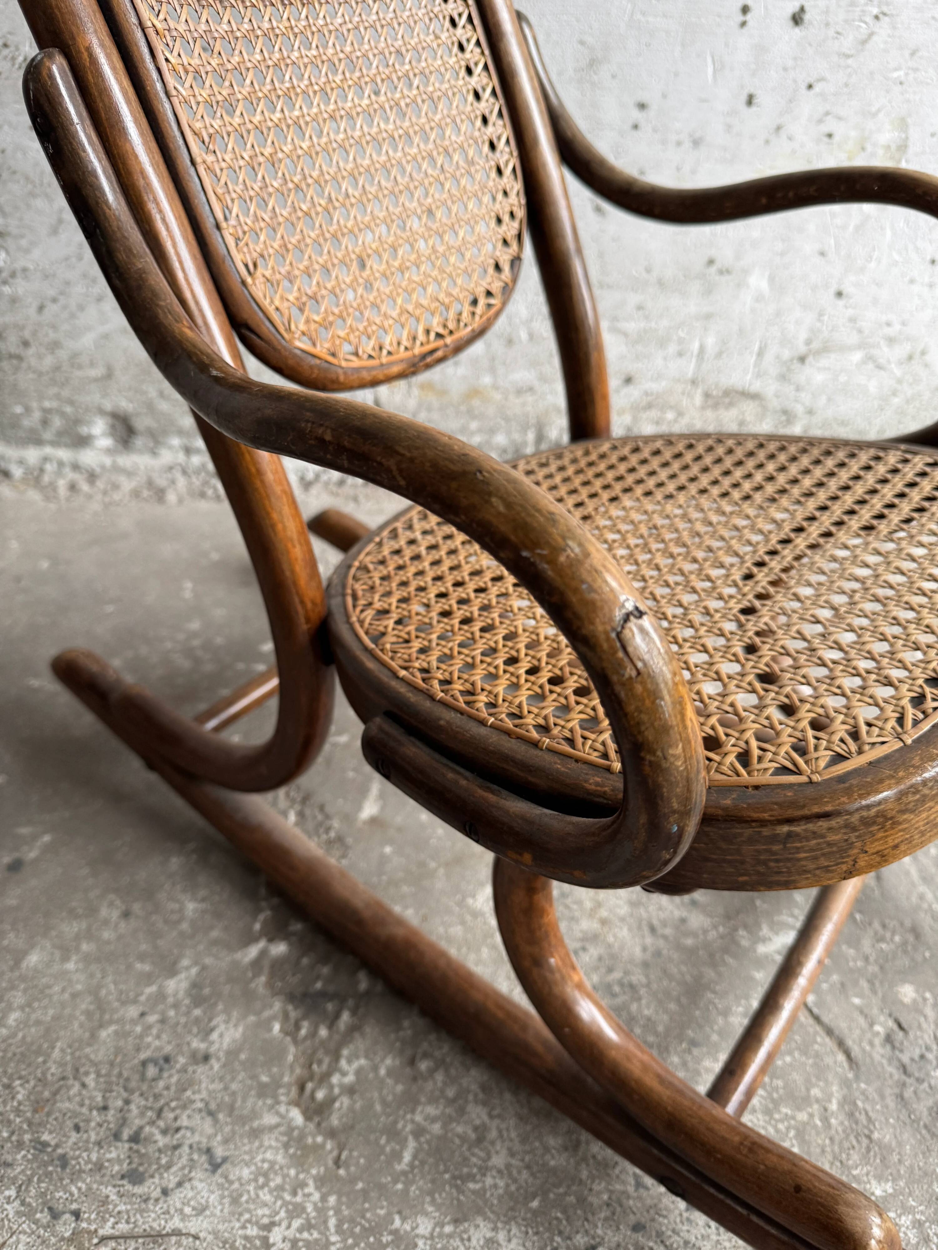 Warm walnut bentwood and cane child's rocking chair early 20th-century
