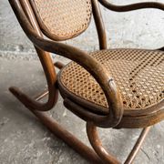 Warm walnut bentwood and cane child's rocking chair early 20th-century