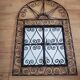 Oriental mirror with wrought iron door