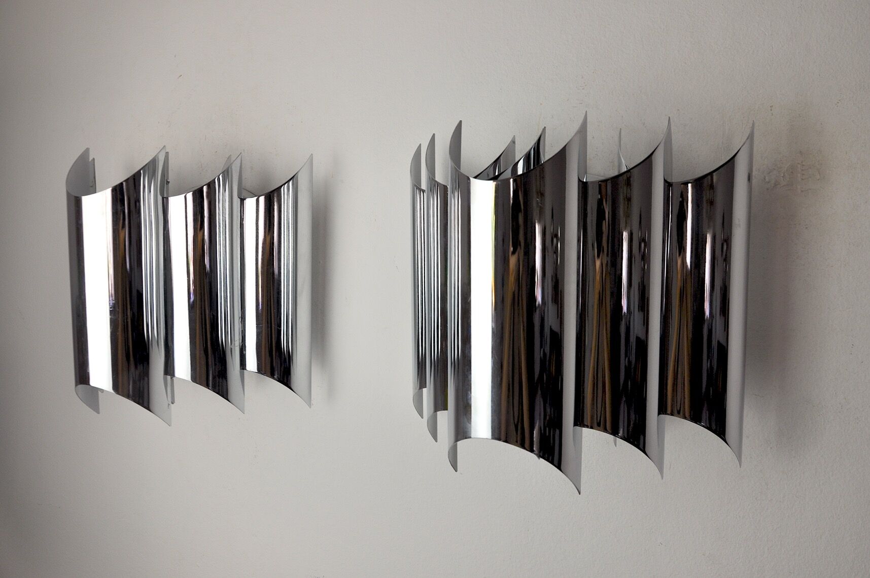 Pair of Raak wall lamps, space-age chrome design, Germany, 1970