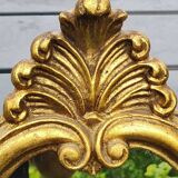 Classic Baroque/Louis XV style mirror. In old gold patinated wood. Palmette/Scroll/Blazon motif decor. Dim 46 x 27 cm