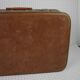Cardboard and brown leather case