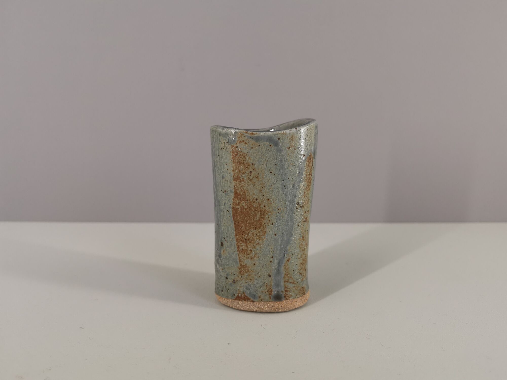 Signed vase in enamelled sandstone with stylized face