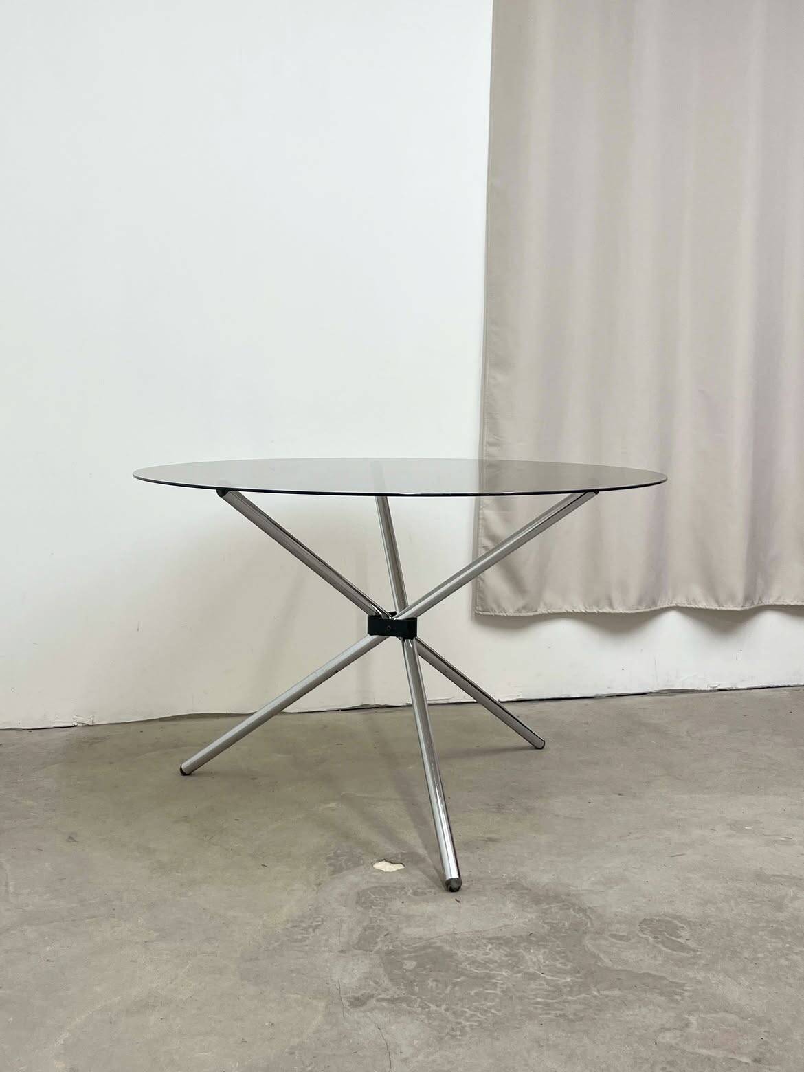Round dining table in chrome and smoked glass.