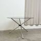 Round dining table in chrome and smoked glass.