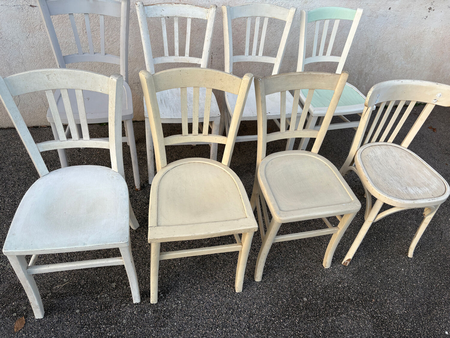 Set of 8 mismatched white bistro chairs