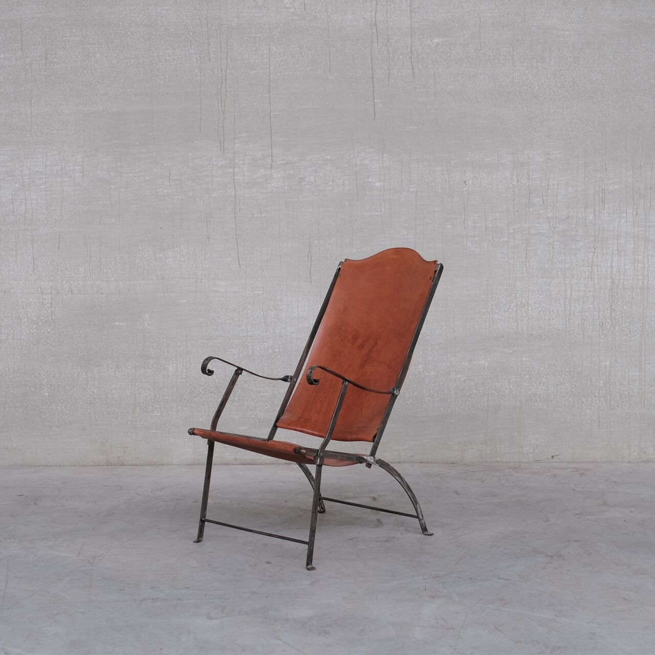 Pair of mid-century leather and metal folding armchairs