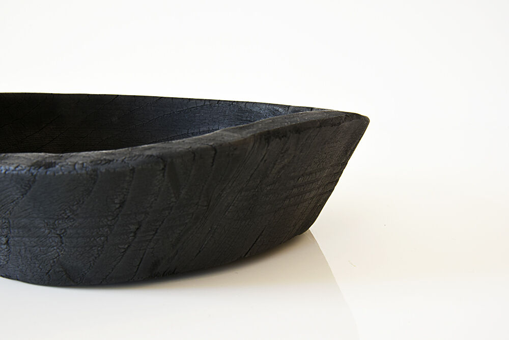 Cut / empty pocket in burning wood. shou-sugi-ban