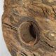 Old wooden pulley wheel on foot