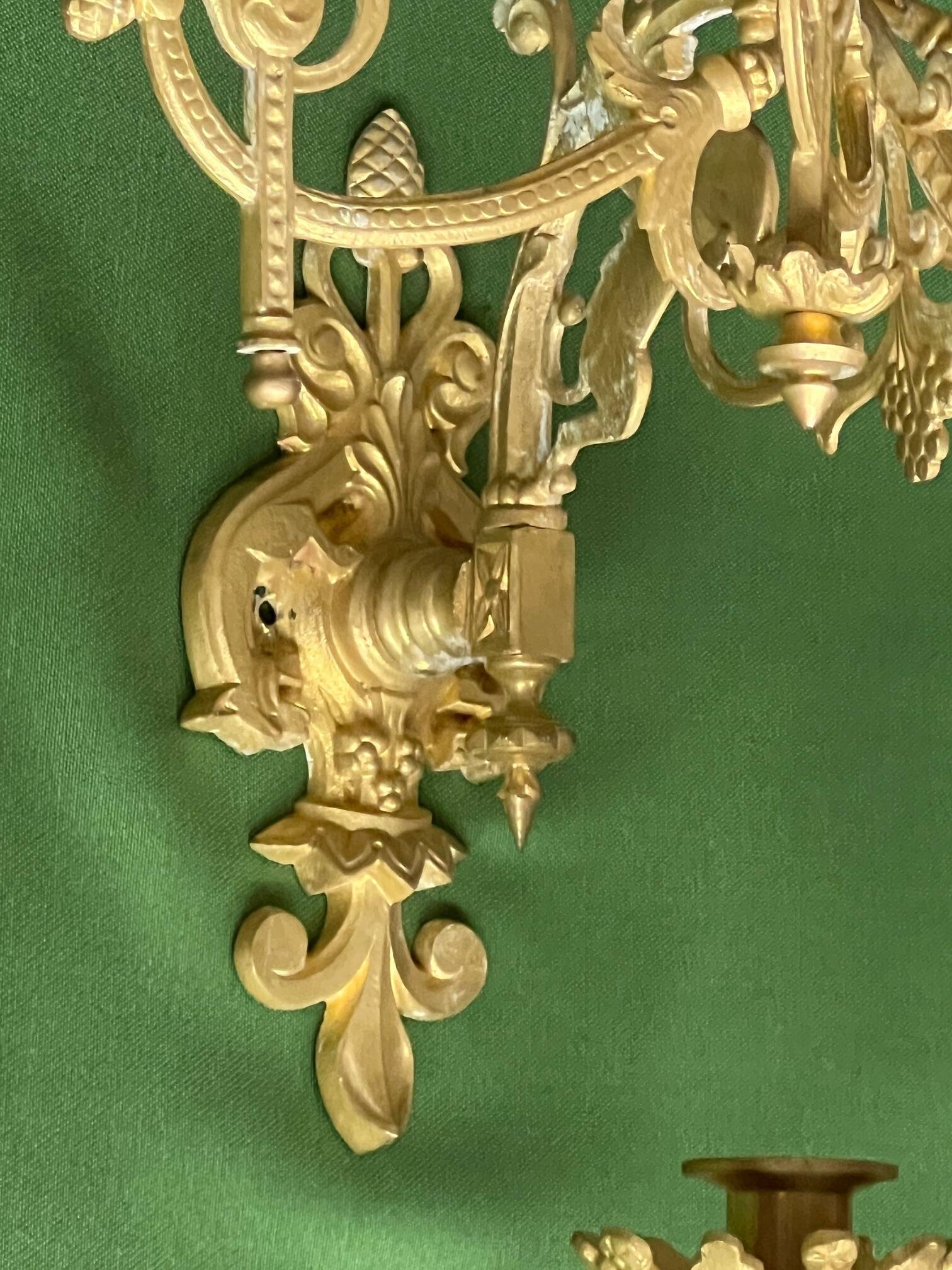 Pair of neo-Gothic wall sconces. Solid gilt bronze.