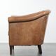 Characterful club chair made of sheepskin leather with light cognac colours