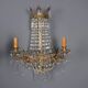 Antique wall sconces in gilded bronze with neoclassical motifs, 20th century.