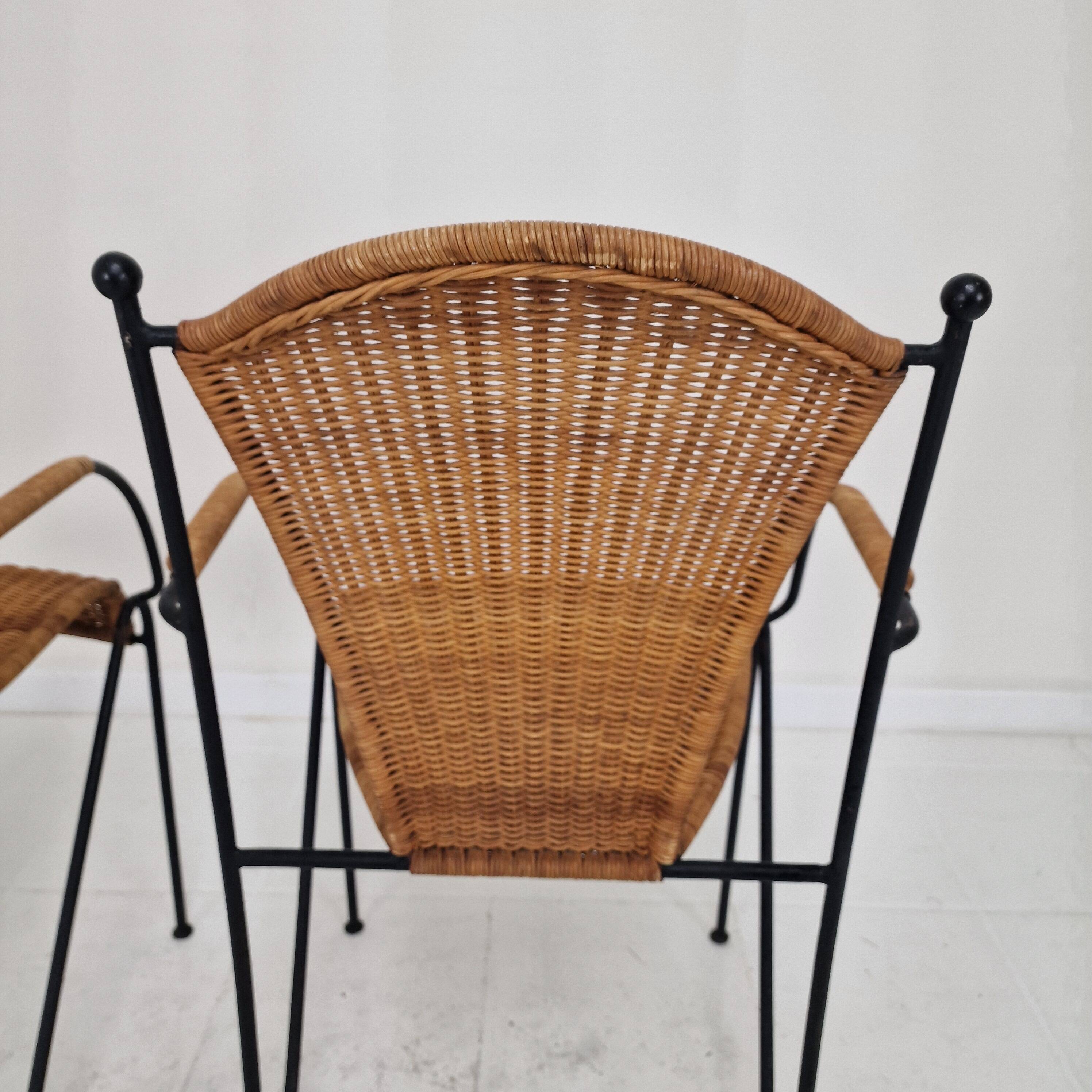 Pair of wicker and iron armchairs by Frederic Weinberg, United States, 1950s.