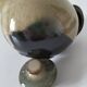 Vintage ceramic teapot with a flame design.