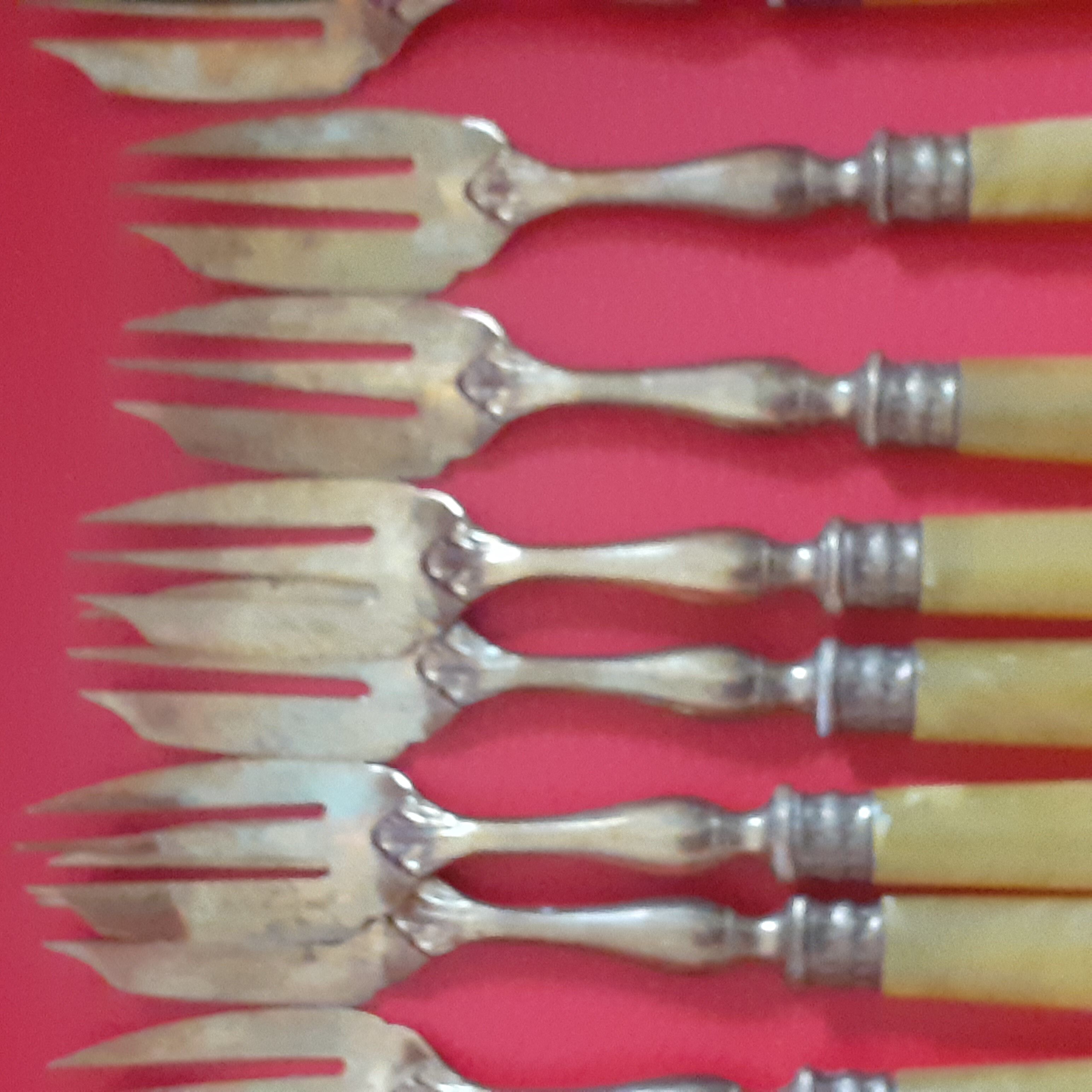 12 Cake forks. Around 1930. Golden metal and yellow Bakelite handle.