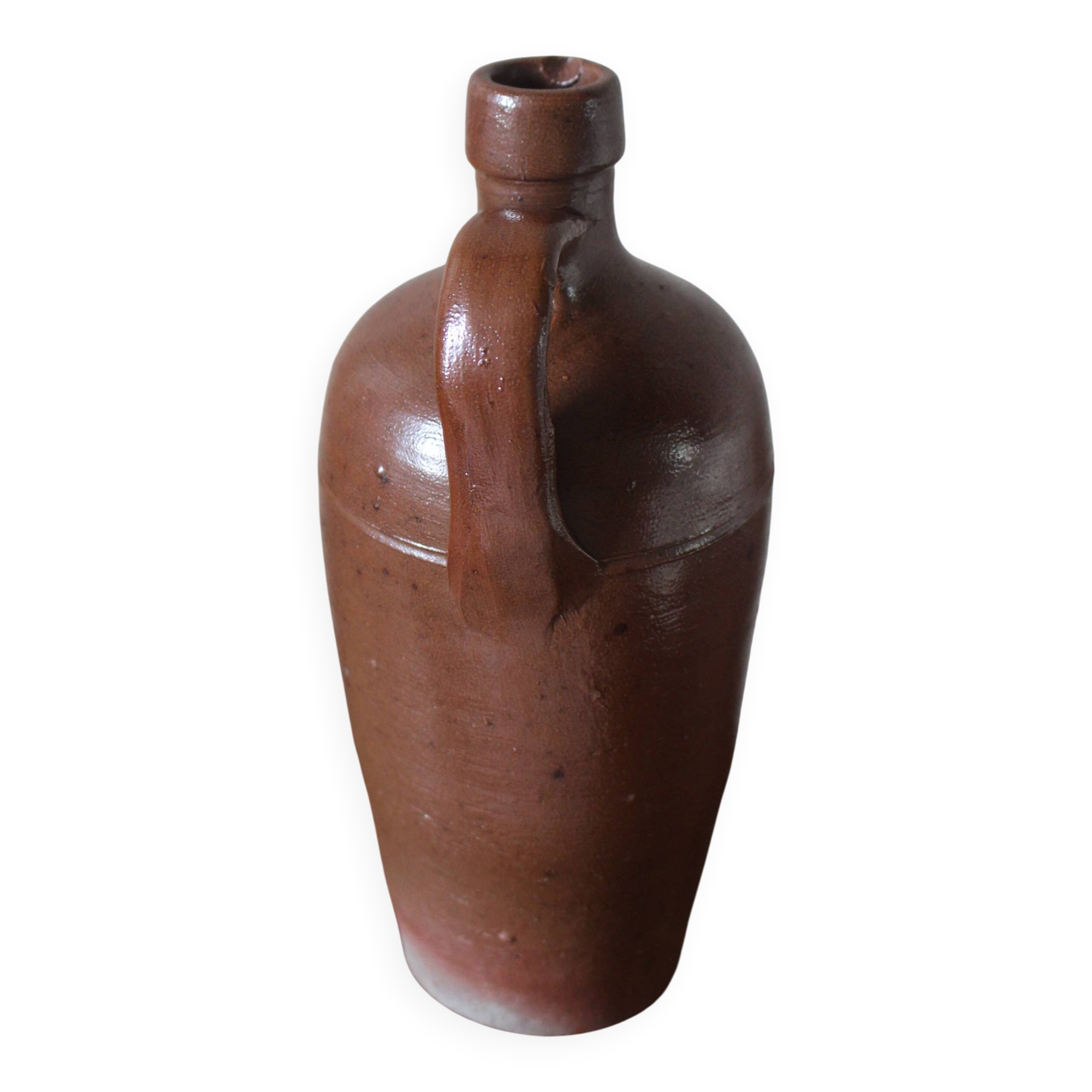 Vintage stoneware liqueur bottle with handle and spout.