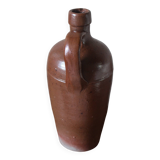 Vintage stoneware liqueur bottle with handle and spout.