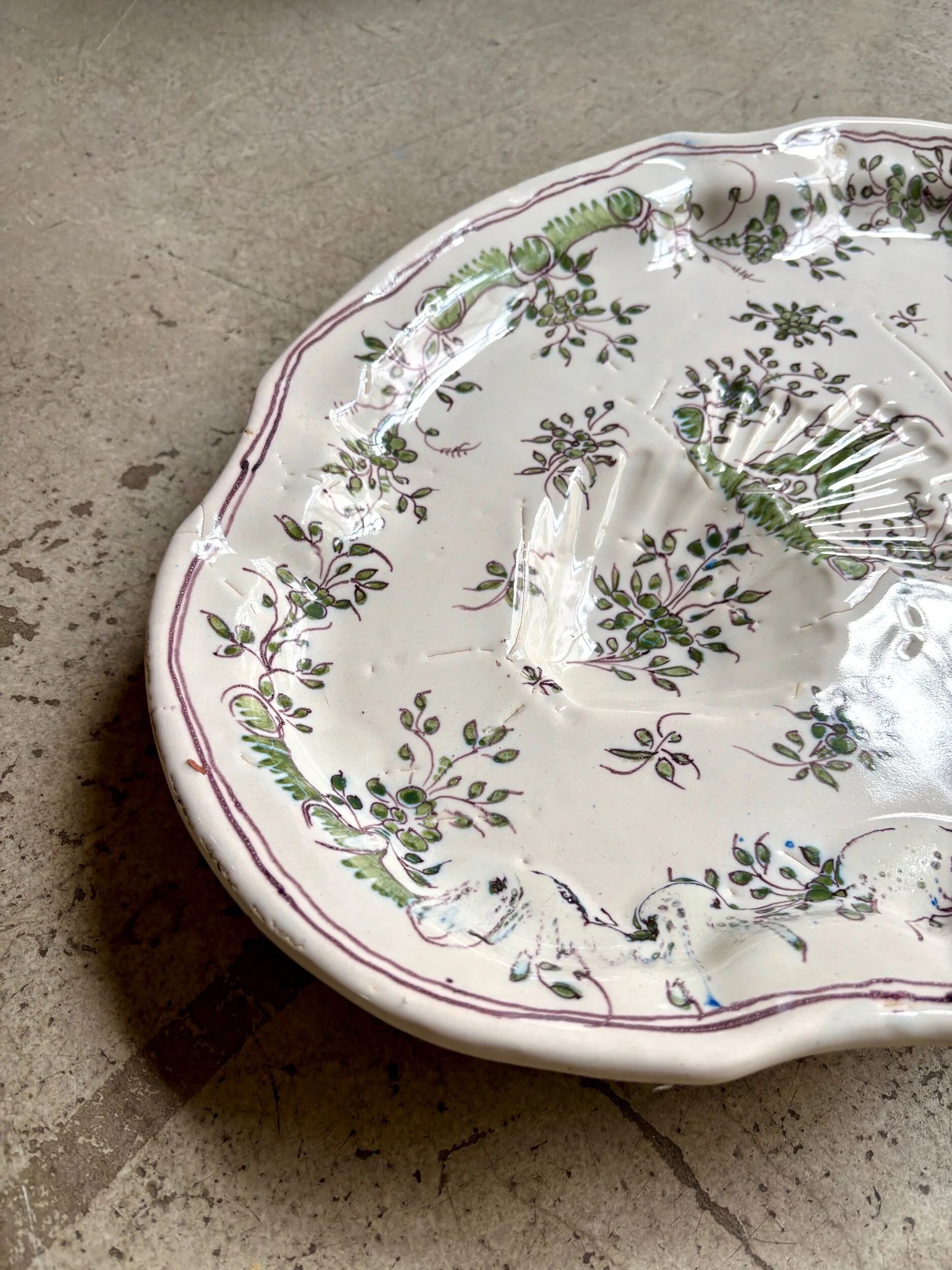 Oval Moustiers plate in cream and green earthenware, 18th century.