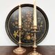 Round plateau, 19th century, painted black with fruit and grape decoration (49 cm)