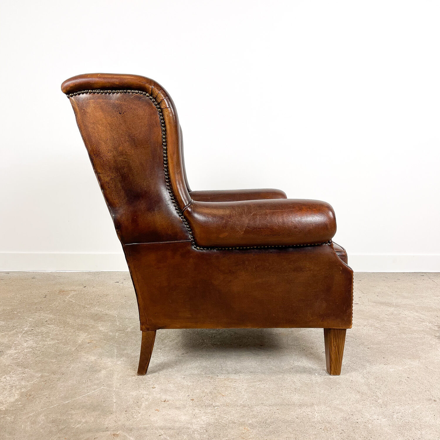 Vintage dark brown sheep leather wingback armchair