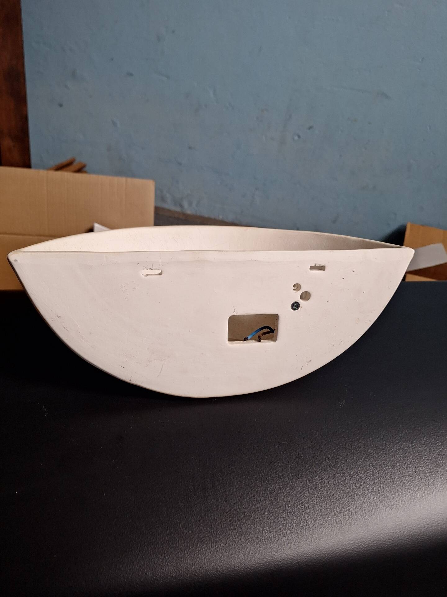 Yellow stoneware half-moon wall light