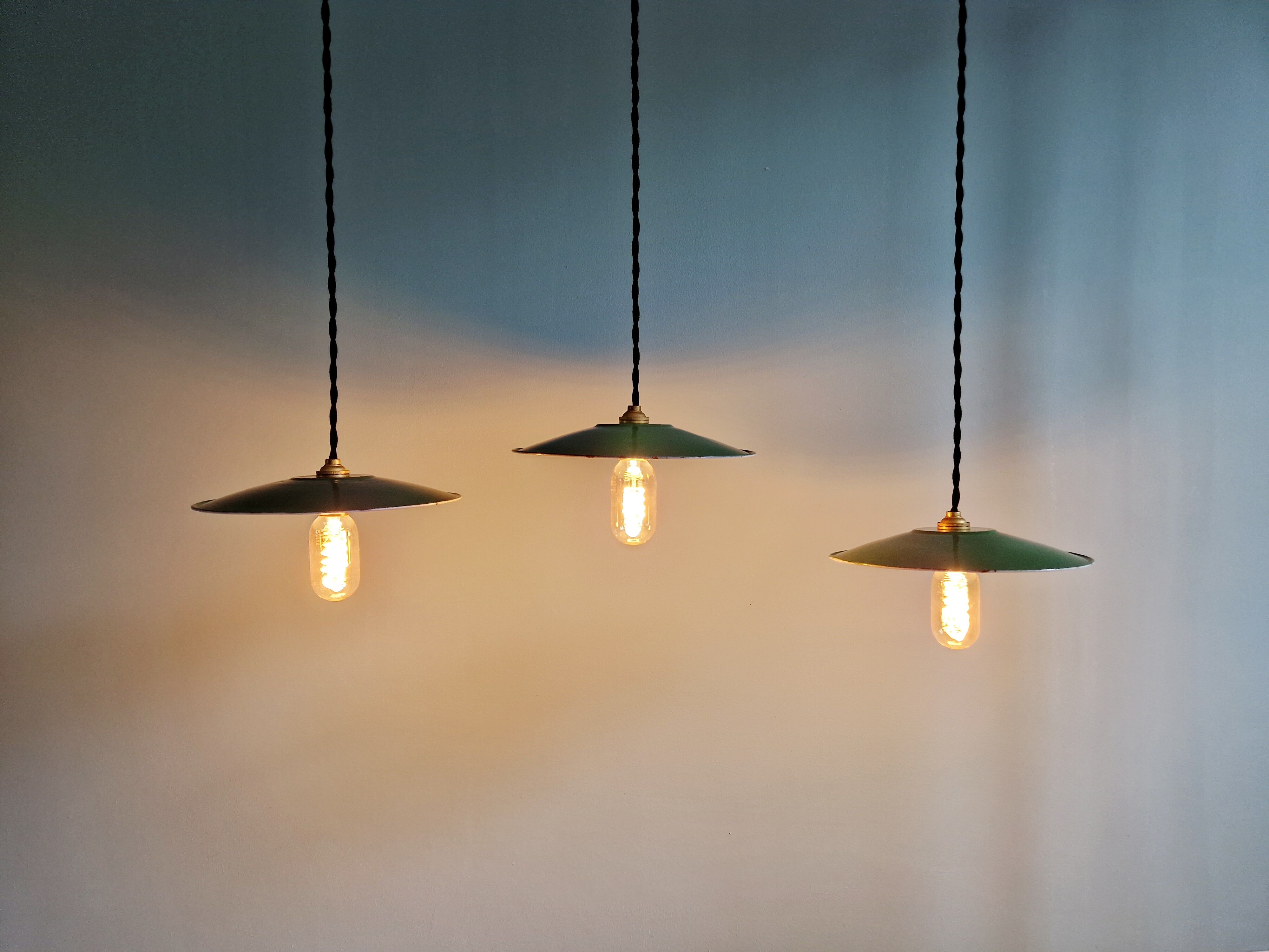Trio of large industrial suspensions in green enamelled sheet metal.