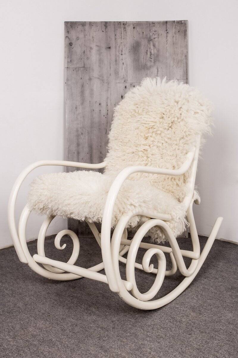 Antique Thonet rocking chair in ivory lacquered bent wood, with a white lamb fur seat.