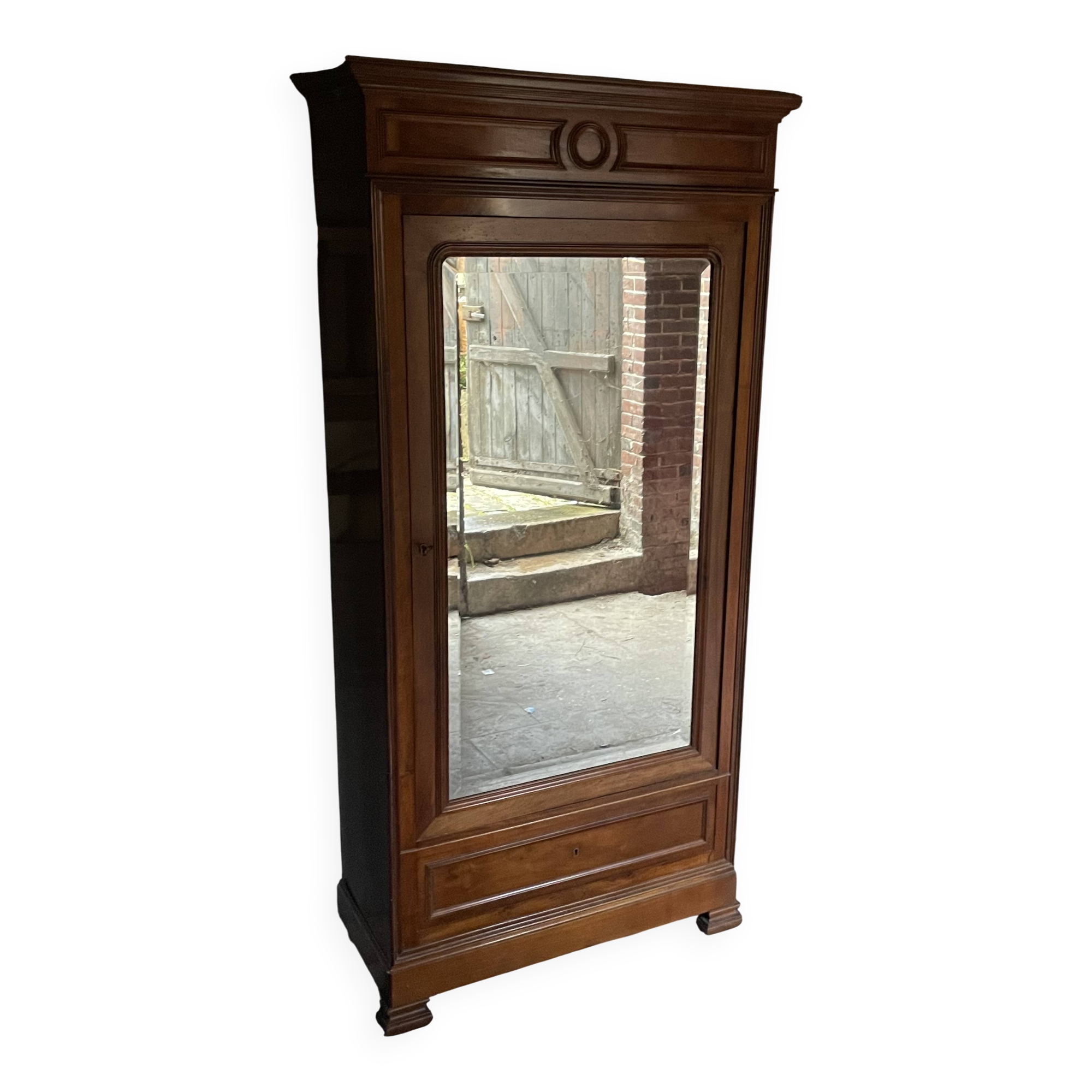 Antique wardrobe with a mirror door.