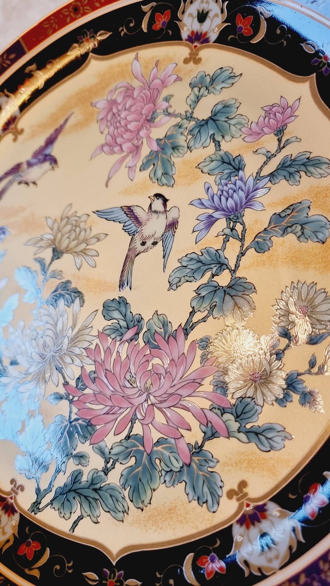 Vintage Japanese decorative plate with chrysanthemum and bird patterns.