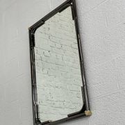 Mirror in black metal and brass with gunmetal finish