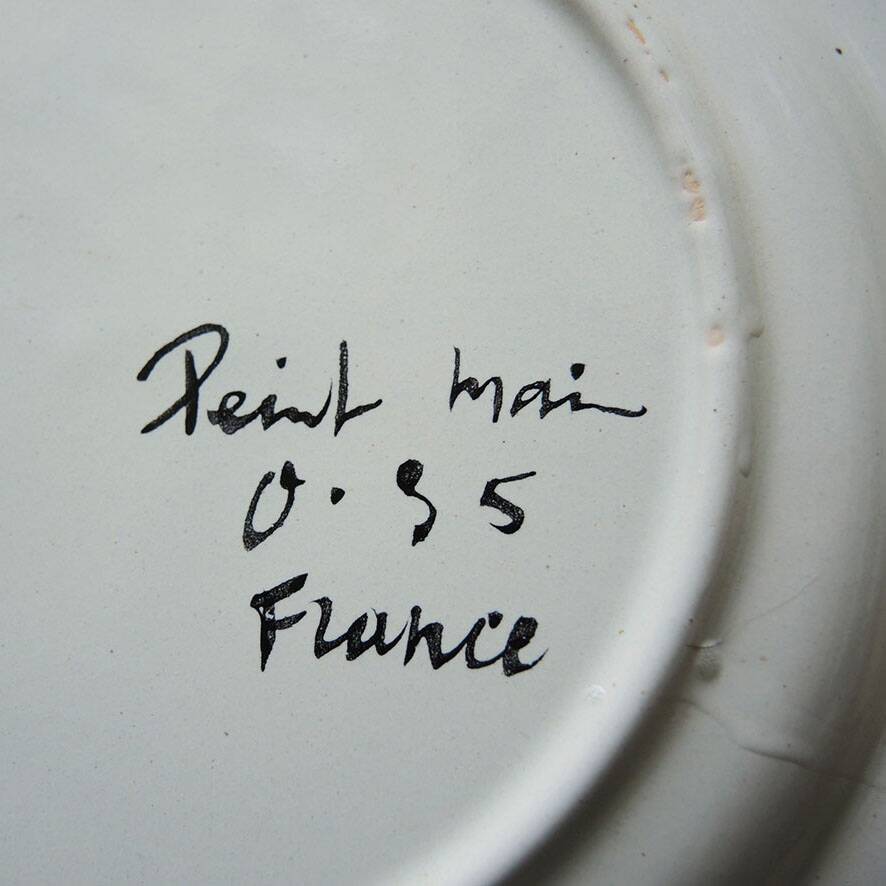 Old ceramic plate, hand-decorated, signed: bird on a fence.