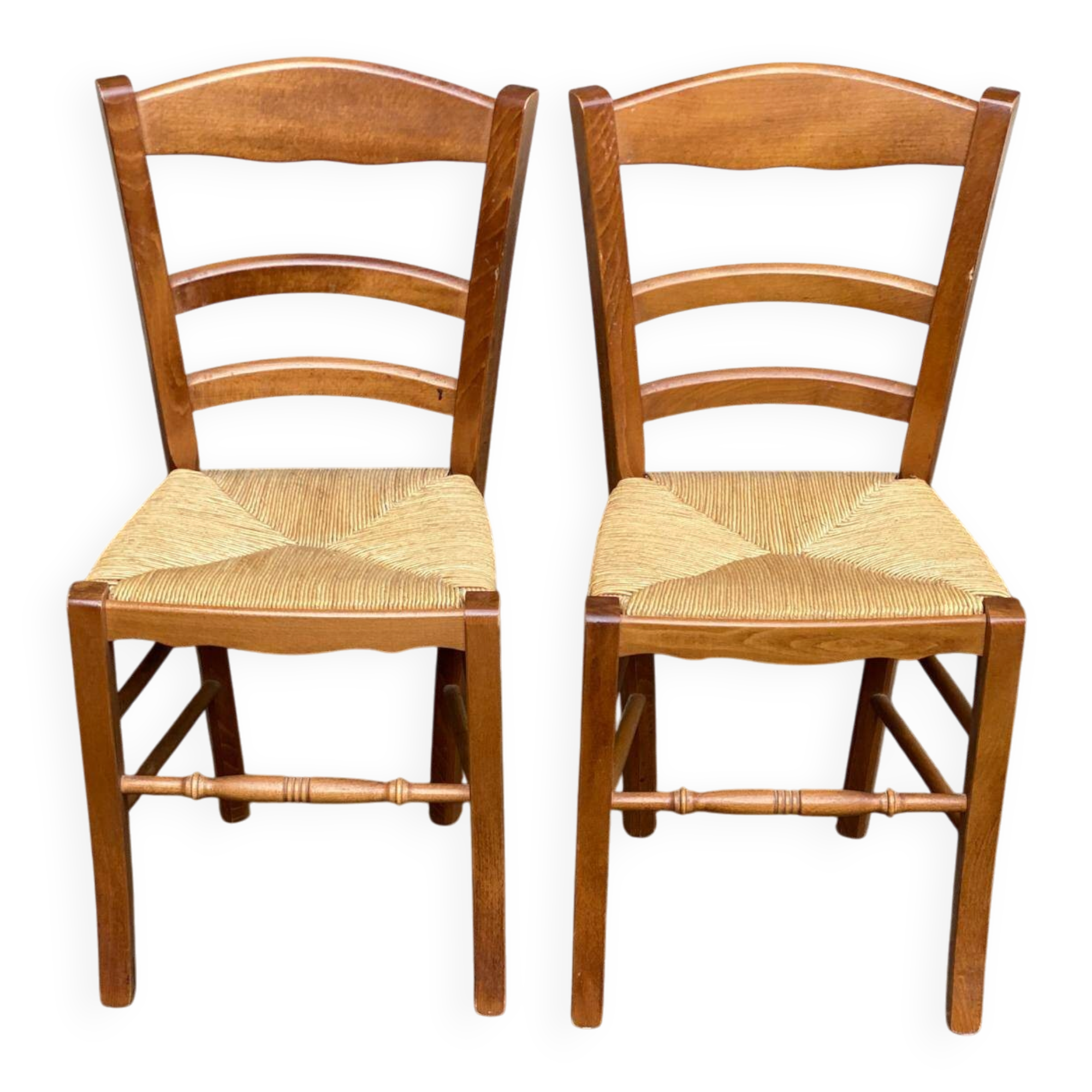 2 wooden dining chairs with rush seats from the 1970s.