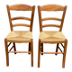 2 wooden dining chairs with rush seats from the 1970s.