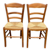 2 wooden dining chairs with rush seats from the 1970s.