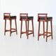 Erik Buck set of three bar stools in teak and leather Dyrlund Denmark 1960