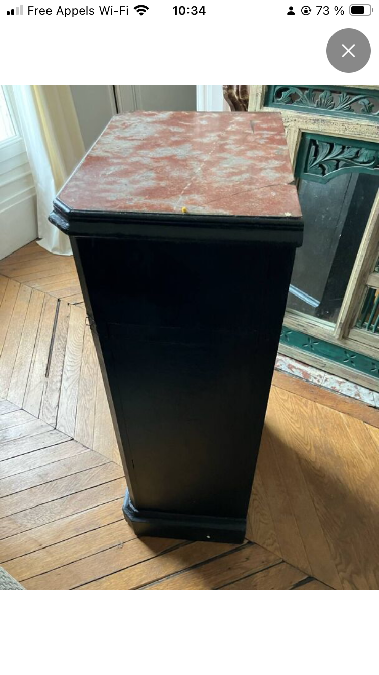 Chest of drawers with a red marble top.