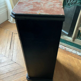 Chest of drawers with a red marble top.