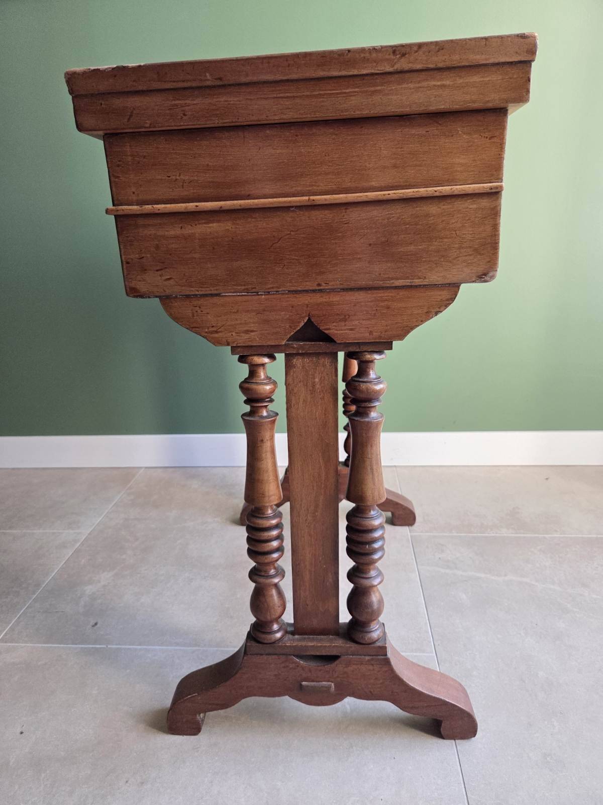 Antique wooden sewing cabinet with mirror and storage.