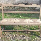 Wooden bench with vintage straw seating