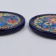 A flat bottom and two enamel bottle bottoms of Longwy