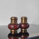 Vintage salt and pepper shaker duo in brass and turned wood.