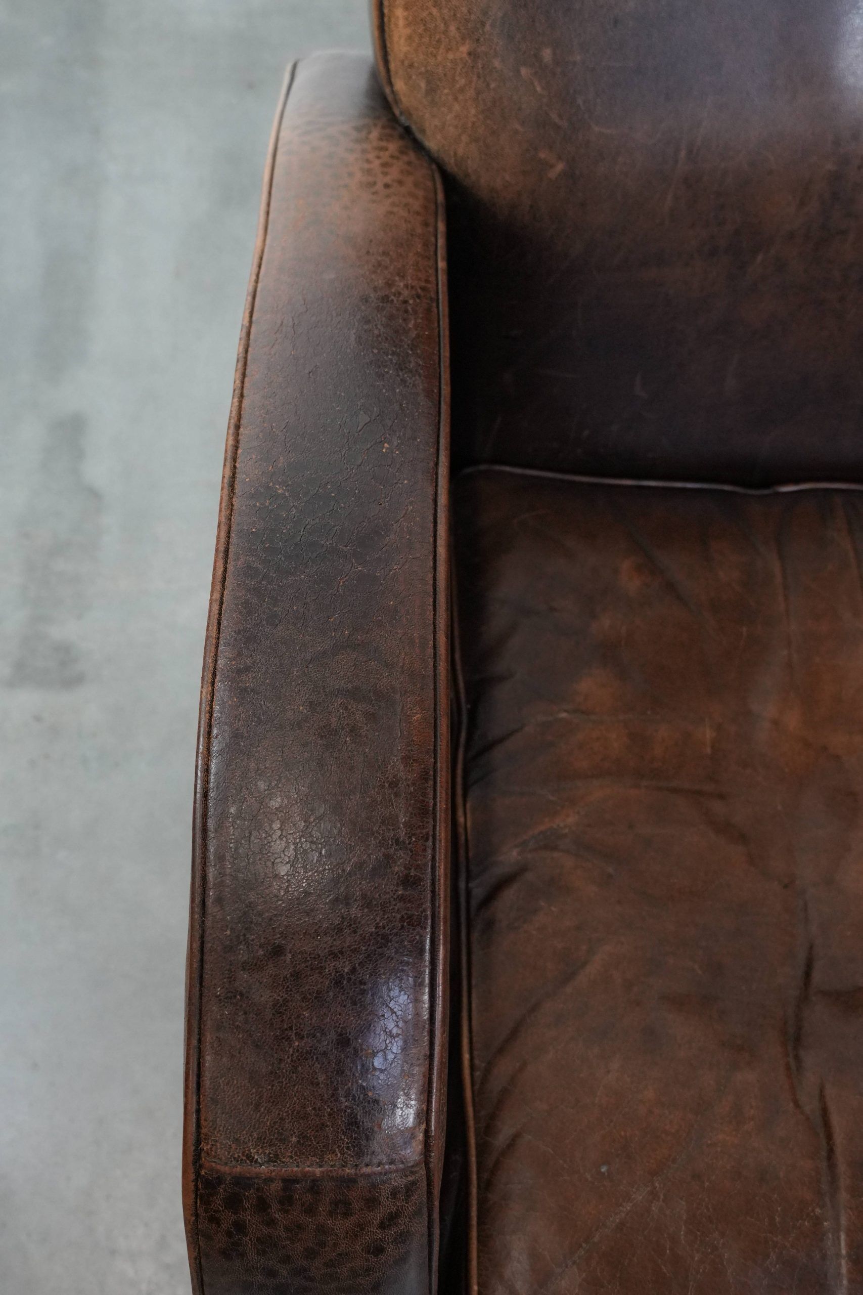 Set of two vintage sheepskin leather design armchairs in a cognac colour