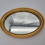Small old oval mirror in gilded wood