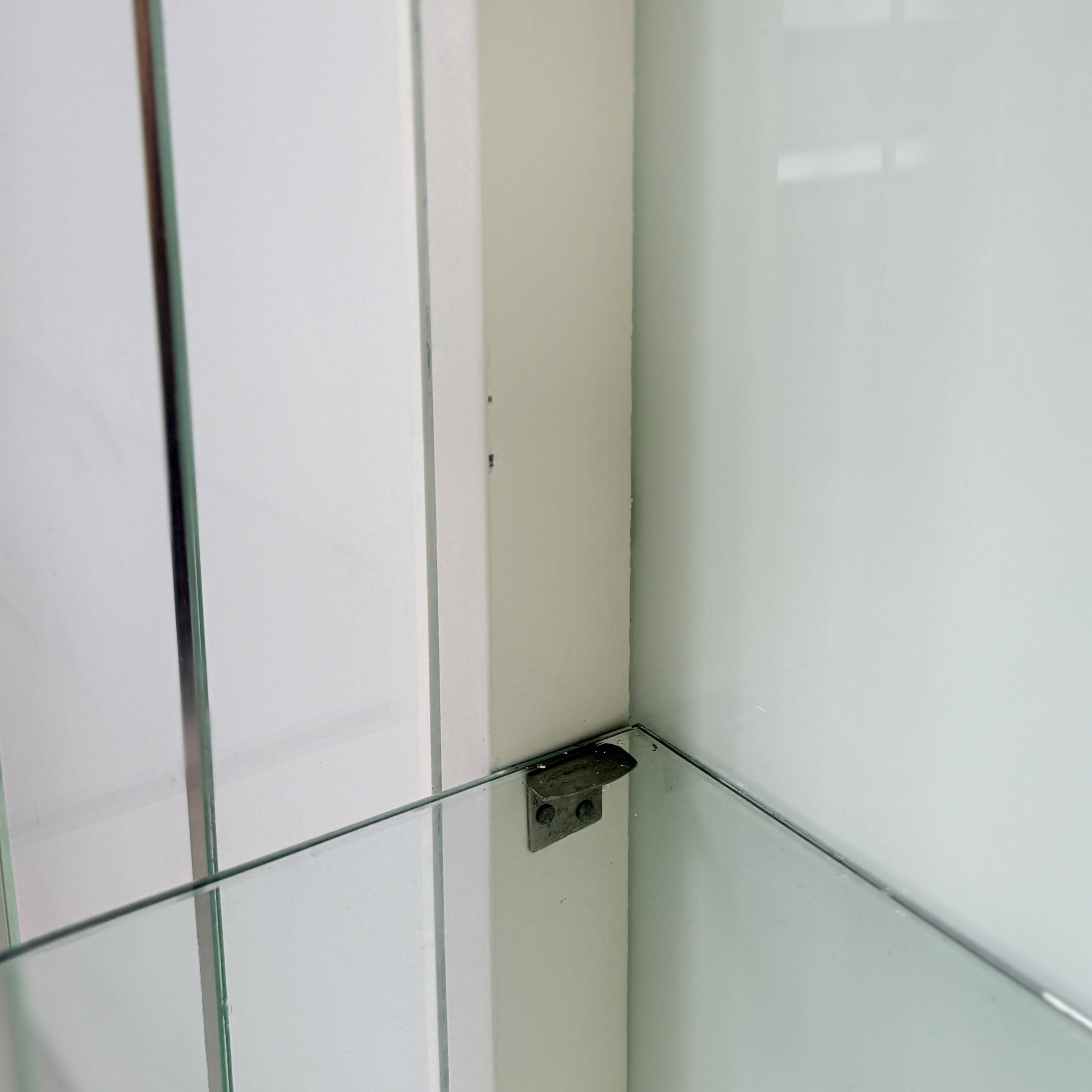 White vintage slatted display case on gold legs