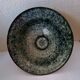Bowl on a circular base or small blue ceramic dish.