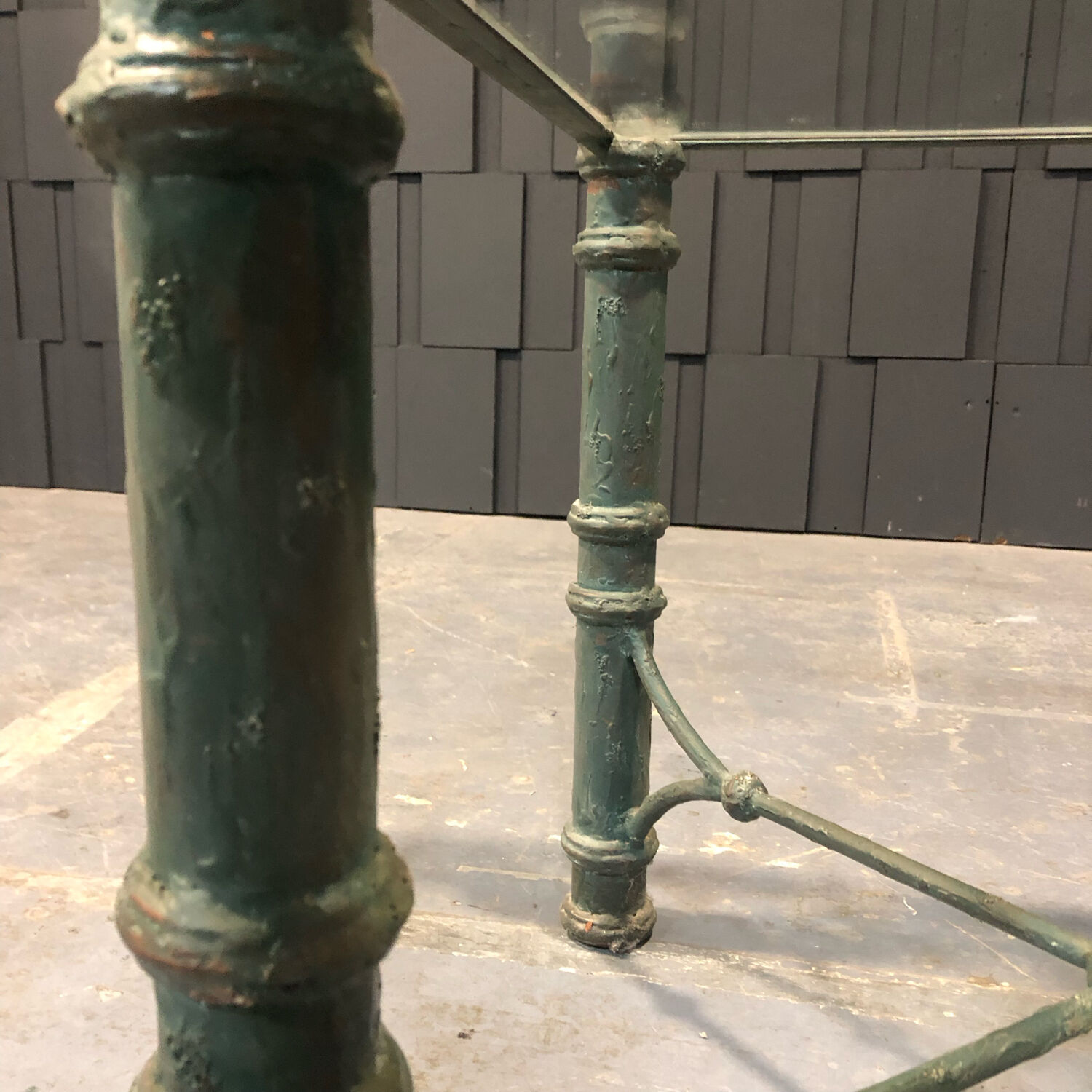 Iron and glass side table with antique patina