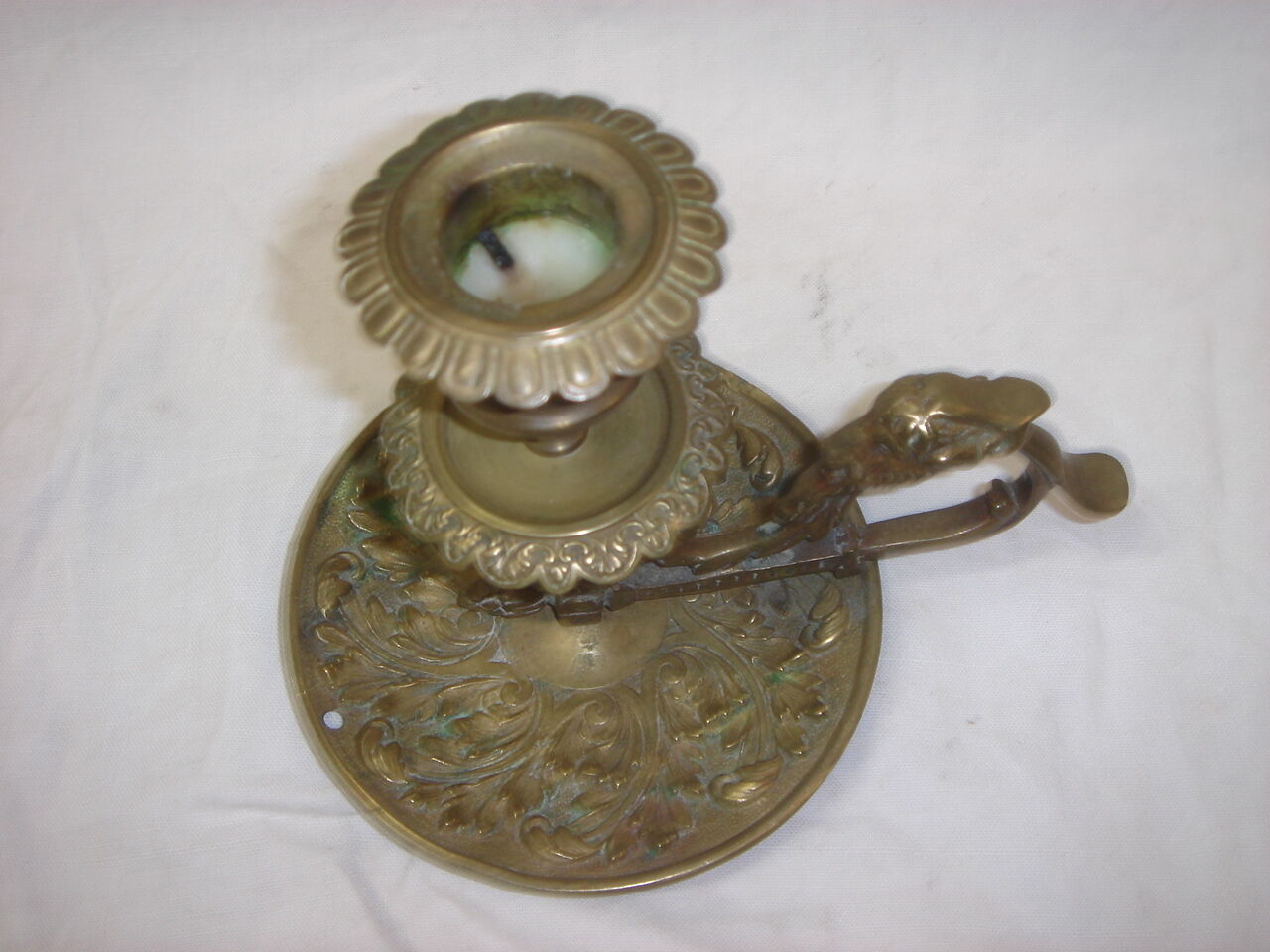 Ancient candlestick in carved bronze ram