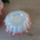 Vintage shell-shaped catchall in iridescent cream and pink ceramic.