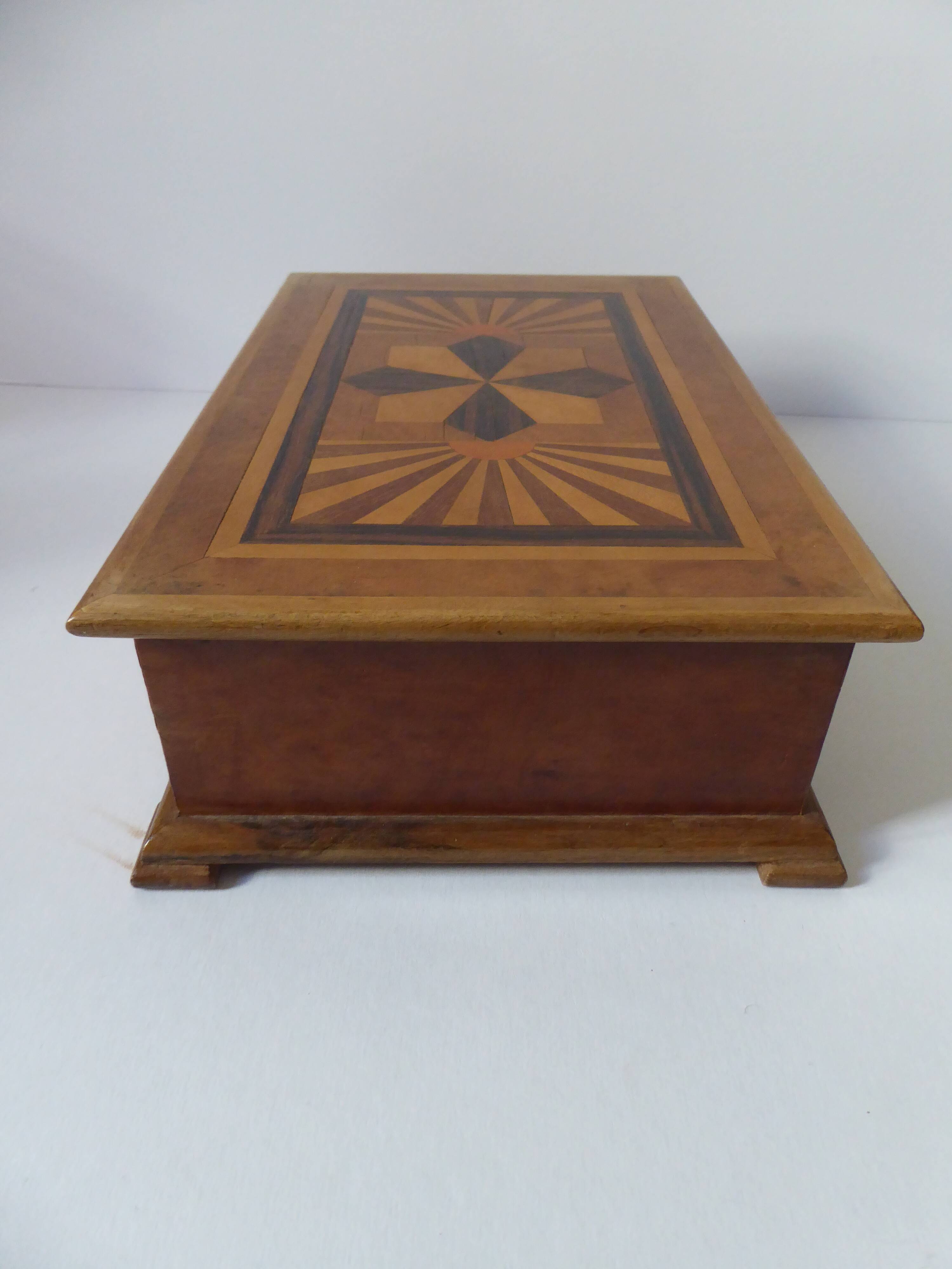 Branded wooden box decorated with suns